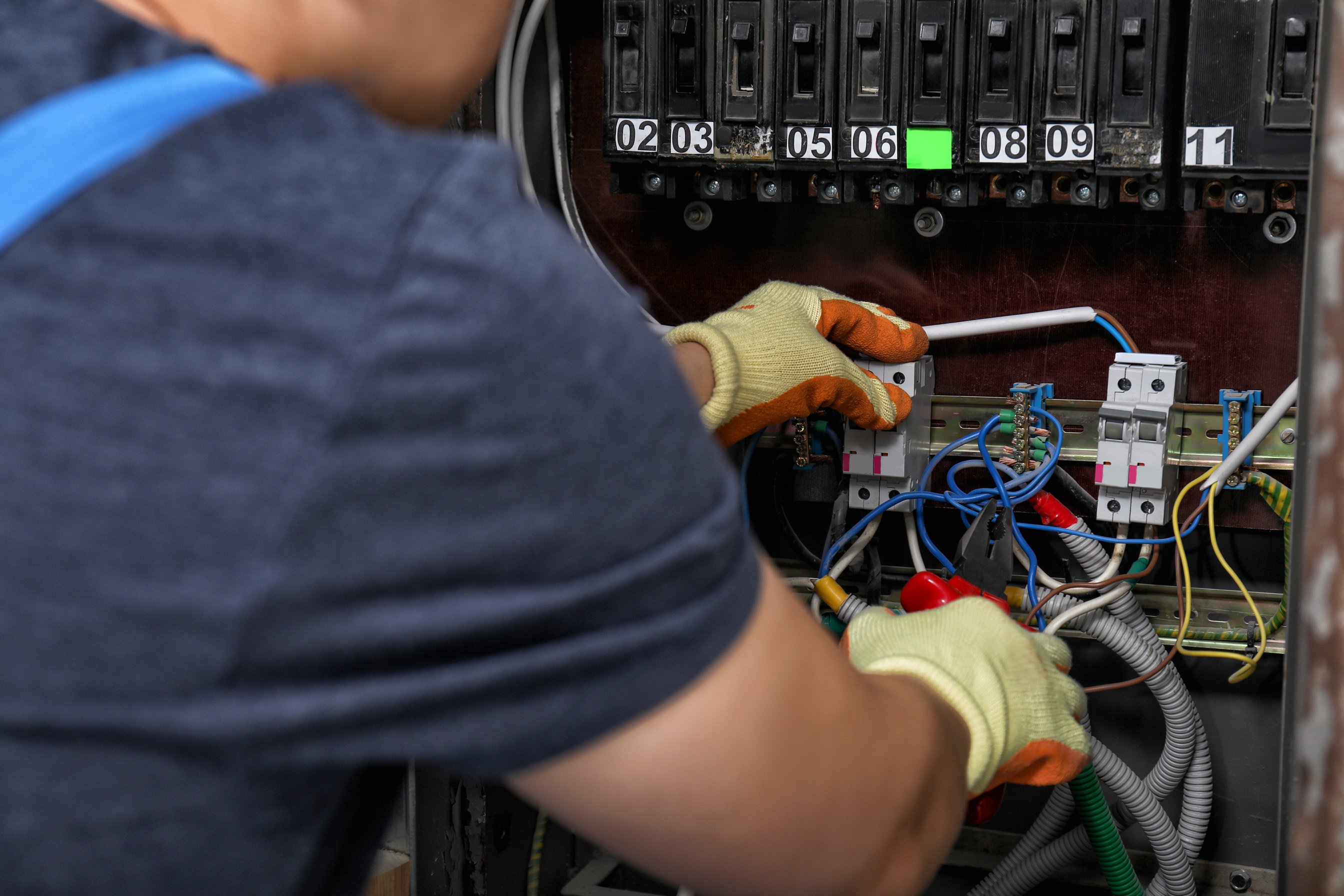 Electrician Connecting Wires in Electric Cabinet